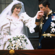 Prince Charles kisses the hand of his bride Princess Diana on the balcony of Buckingham Palace on their wedding day.